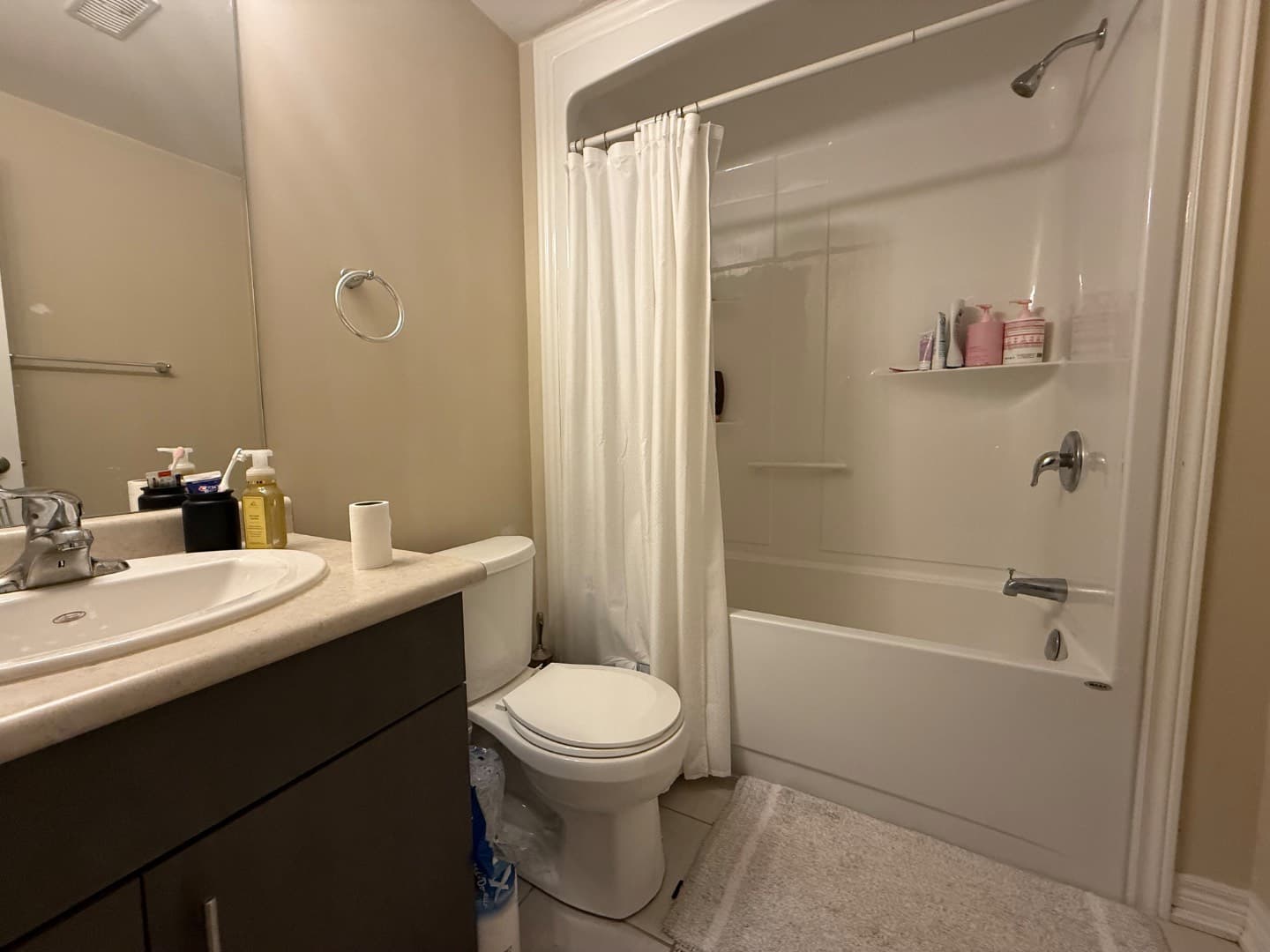 Basement full bathroom with tub, shower and vanity