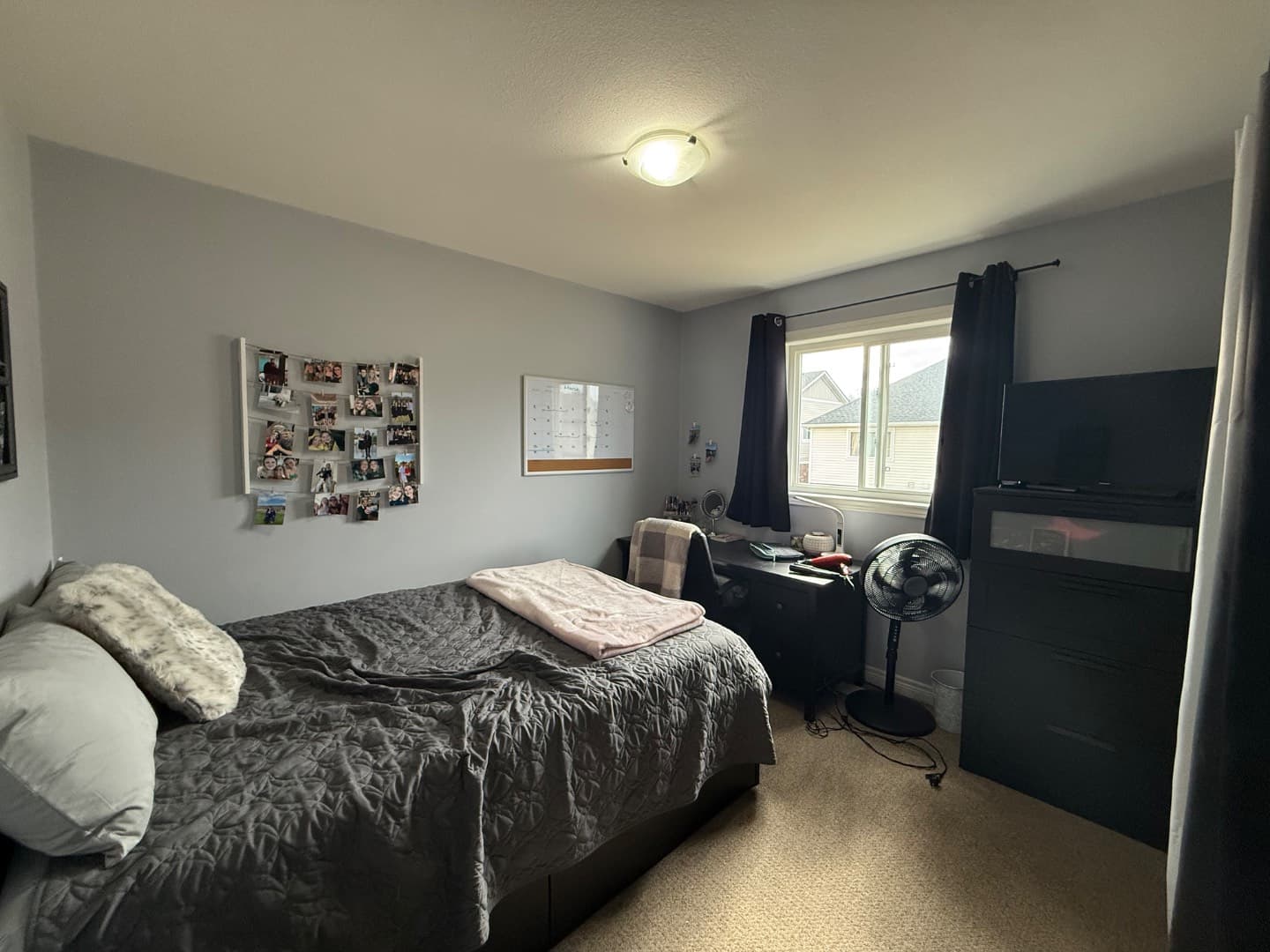 Furnished bedroom with double bed, dresser and study desk